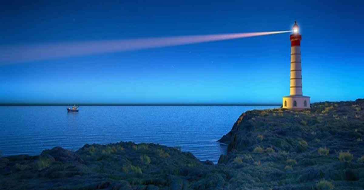 A lighthouse shining it beam at night over the ocean