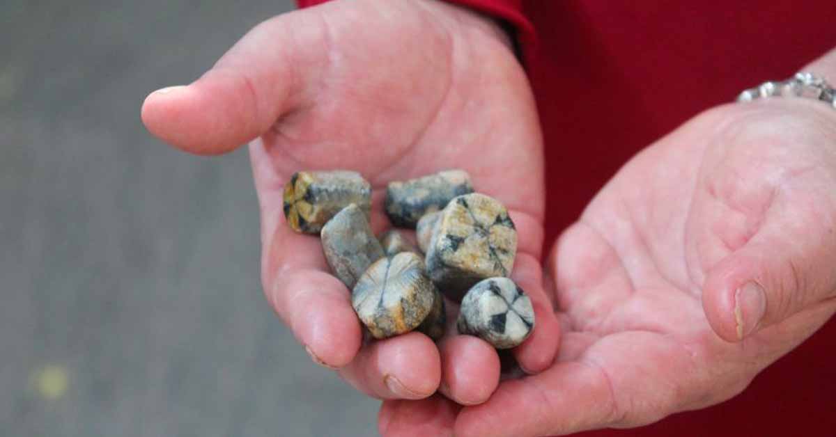 The Cross Stone of Laraquete held in the hand of a local man