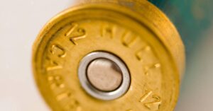 the percussion cap at the end of a bullet